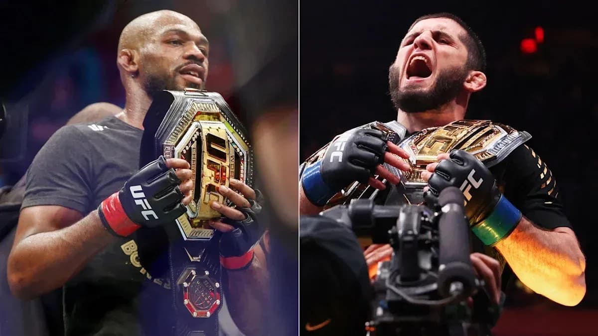 Two UFC fighters holding championship belts Two UFC fighters holding championship belts