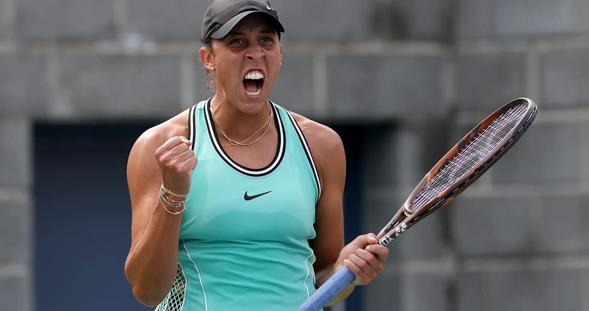Tennis player celebrating with racket raised in victory Tennis player celebrating with racket raised in victory