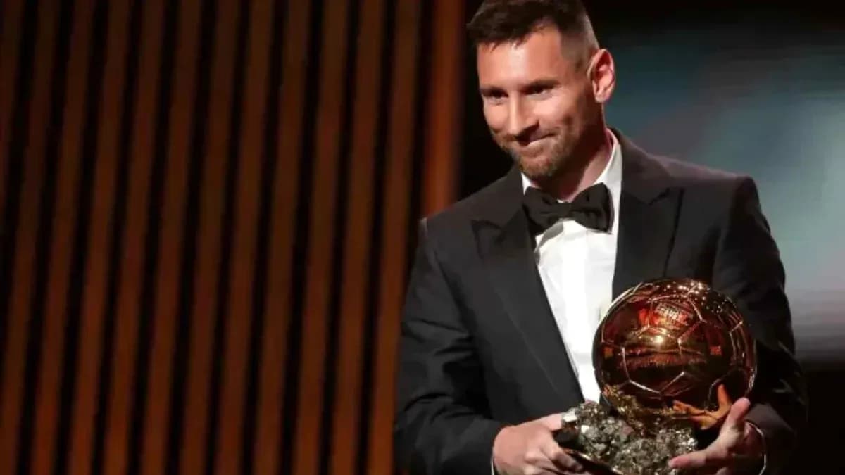 Player holding Ballon d'Or award on stage Player holding Ballon d'Or award on stage