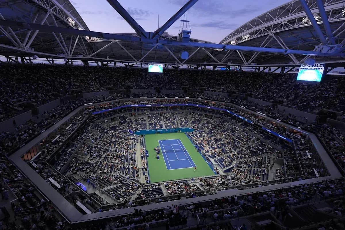 Crowd watching tennis match in stadium at dusk Crowd watching tennis match in stadium at dusk