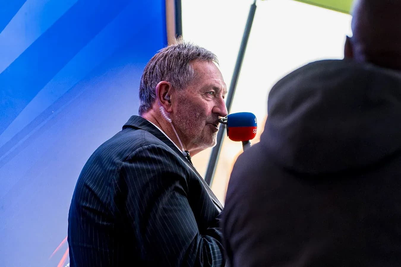 Commentator speaking into microphone at event Commentator speaking into microphone at event