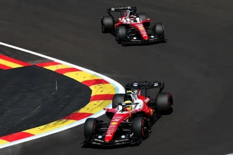 Two Ferrari cars navigating a racetrack corner Two Ferrari cars navigating a racetrack corner