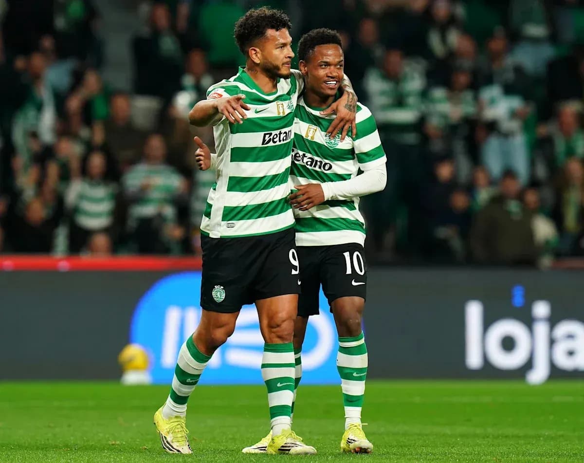 Two Sporting CP players celebrating a goal together Two Sporting CP players celebrating a goal together