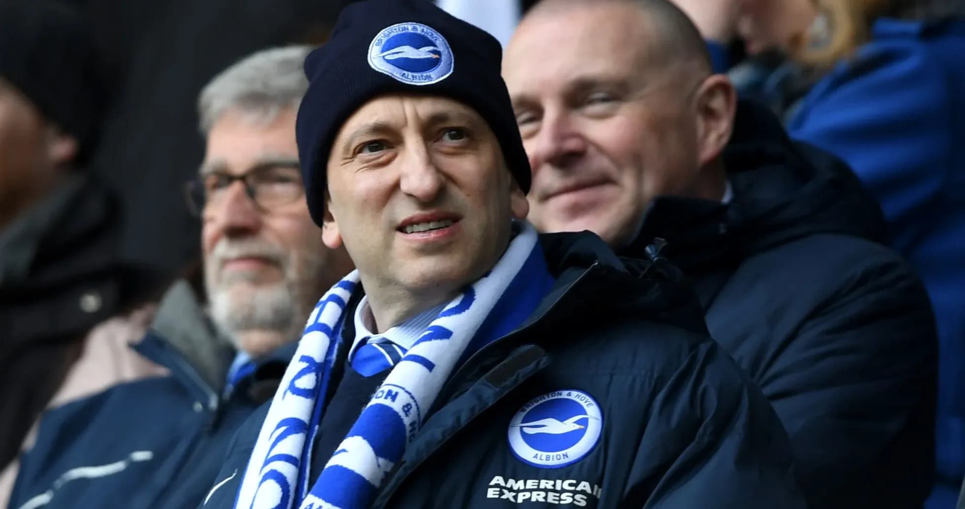Man wearing Brighton scarf and beanie in stadium Man wearing Brighton scarf and beanie in stadium