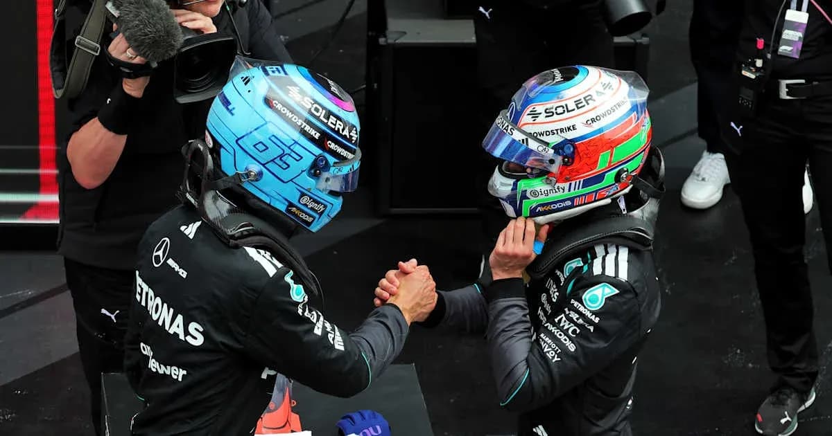 Two Formula 1 drivers shaking hands after race Two Formula 1 drivers shaking hands after race