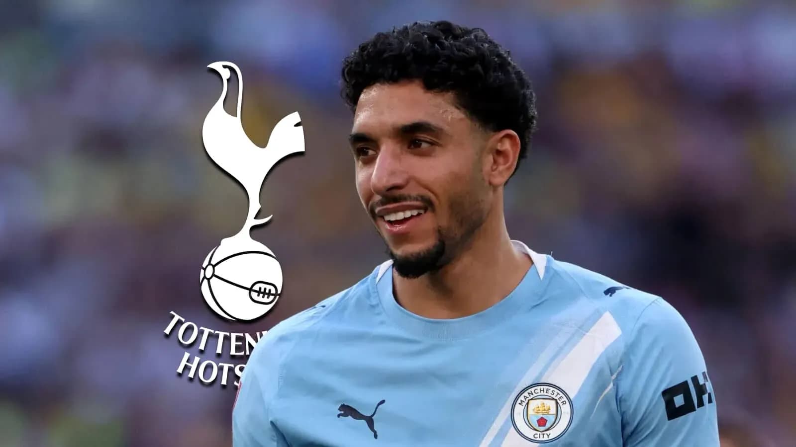 Player smiling in Manchester City jersey with Tottenham logo Player smiling in Manchester City jersey with Tottenham logo