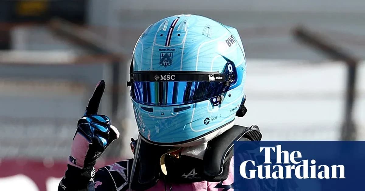 Racing driver celebrating with raised finger in helmet Racing driver celebrating with raised finger in helmet