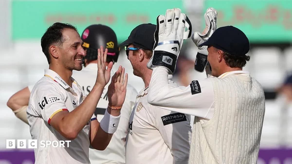 Players celebrating a wicket during a cricket match Players celebrating a wicket during a cricket match