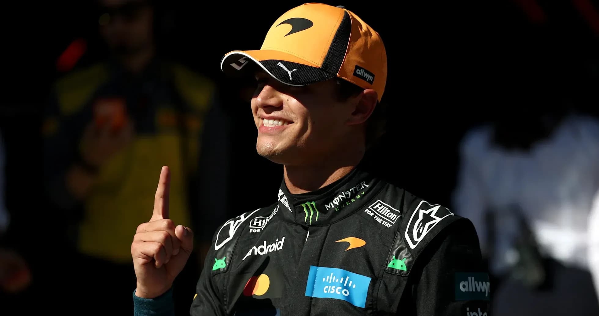 Driver celebrating with a finger raised in victory Driver celebrating with a finger raised in victory