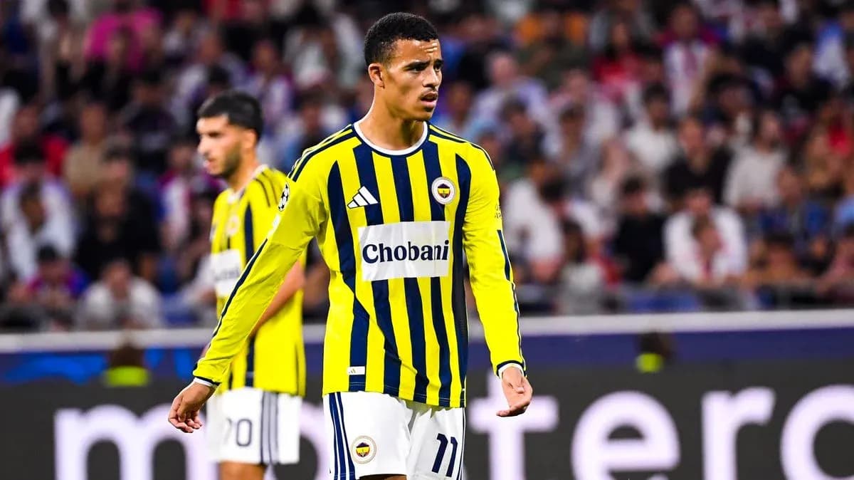 Fenerbahçe player during match with fans in background Fenerbahçe player during match with fans in background
