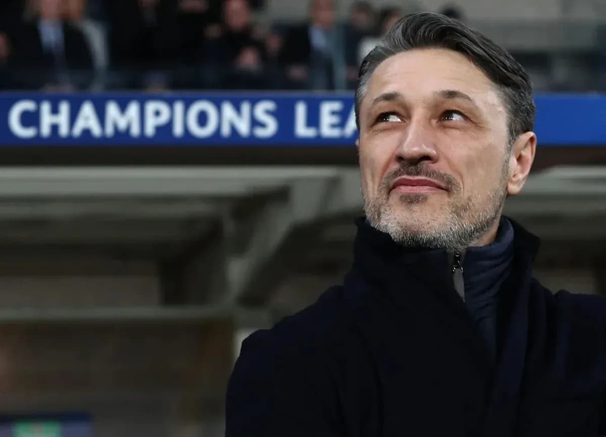 Coach observing match under Champions League banner Coach observing match under Champions League banner