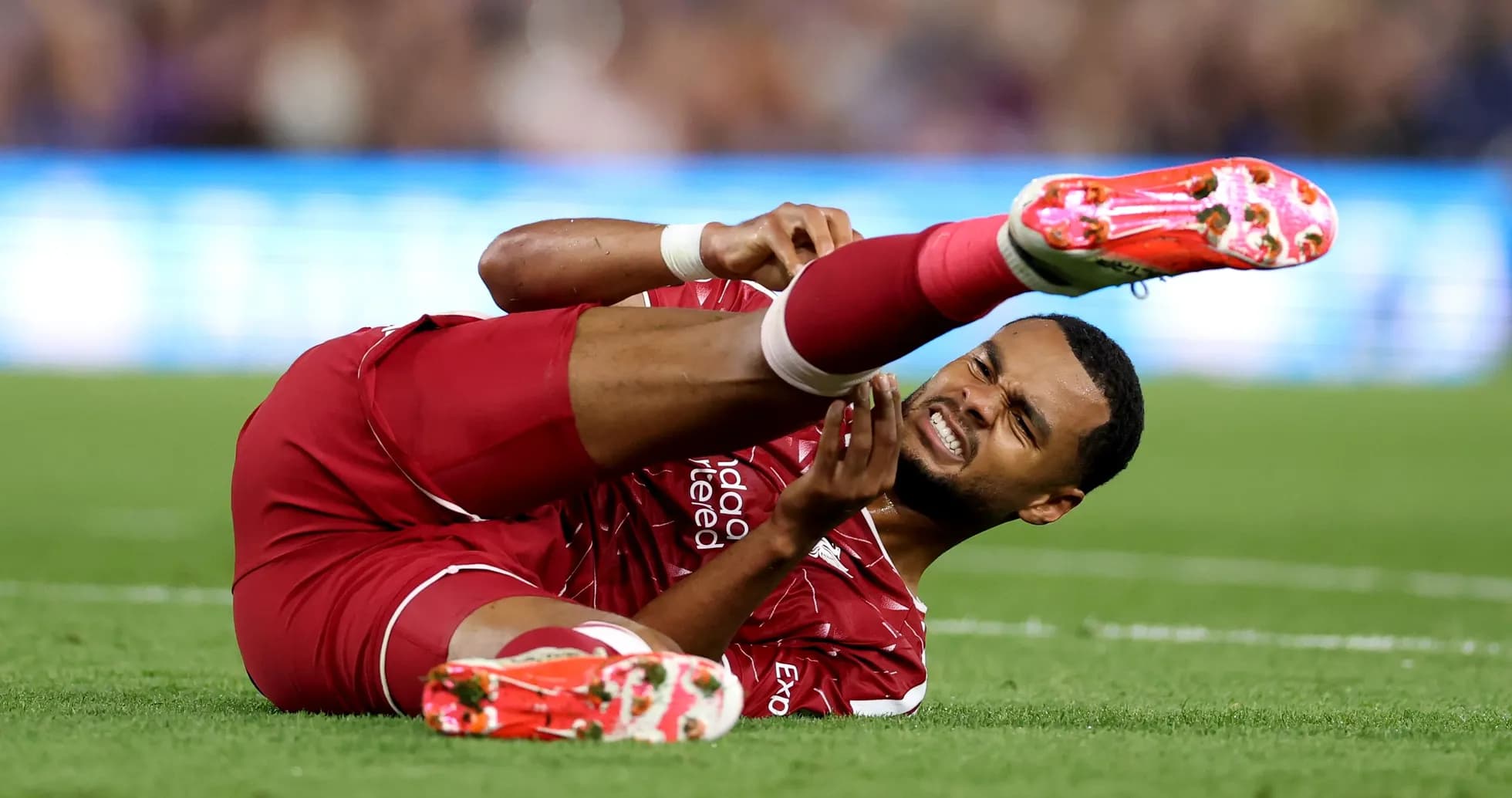 Player lying on field with injured leg Player lying on field with injured leg