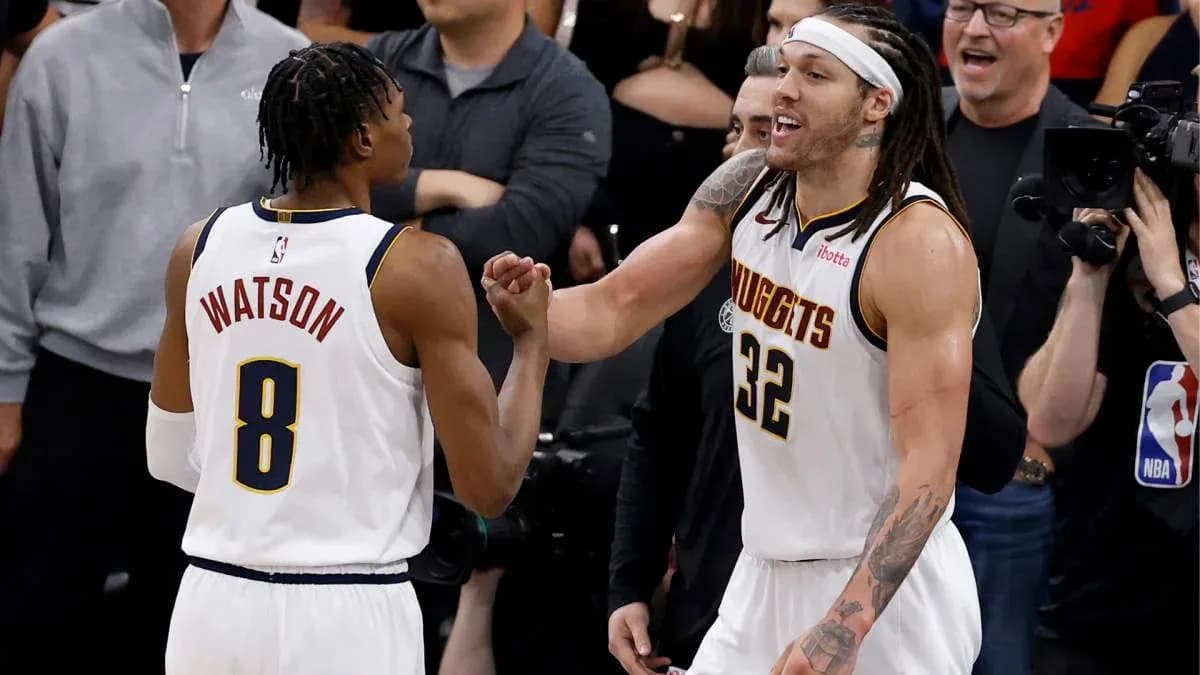 Two basketball players celebrating on court Two basketball players celebrating on court