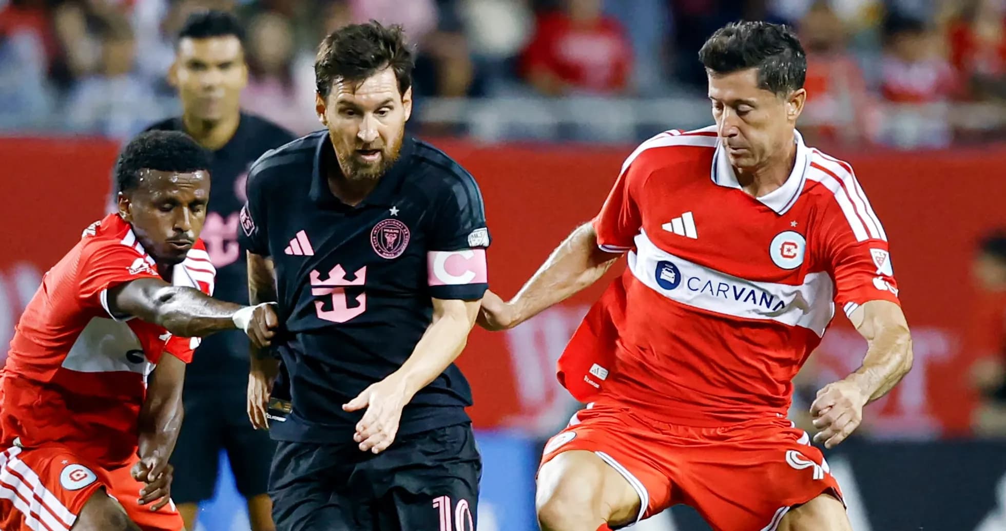 Players battling for the ball during a soccer match Players battling for the ball during a soccer match