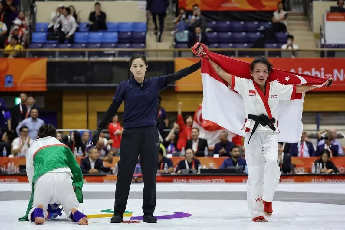 Athlete celebrating victory with national flag in dojo Athlete celebrating victory with national flag in dojo