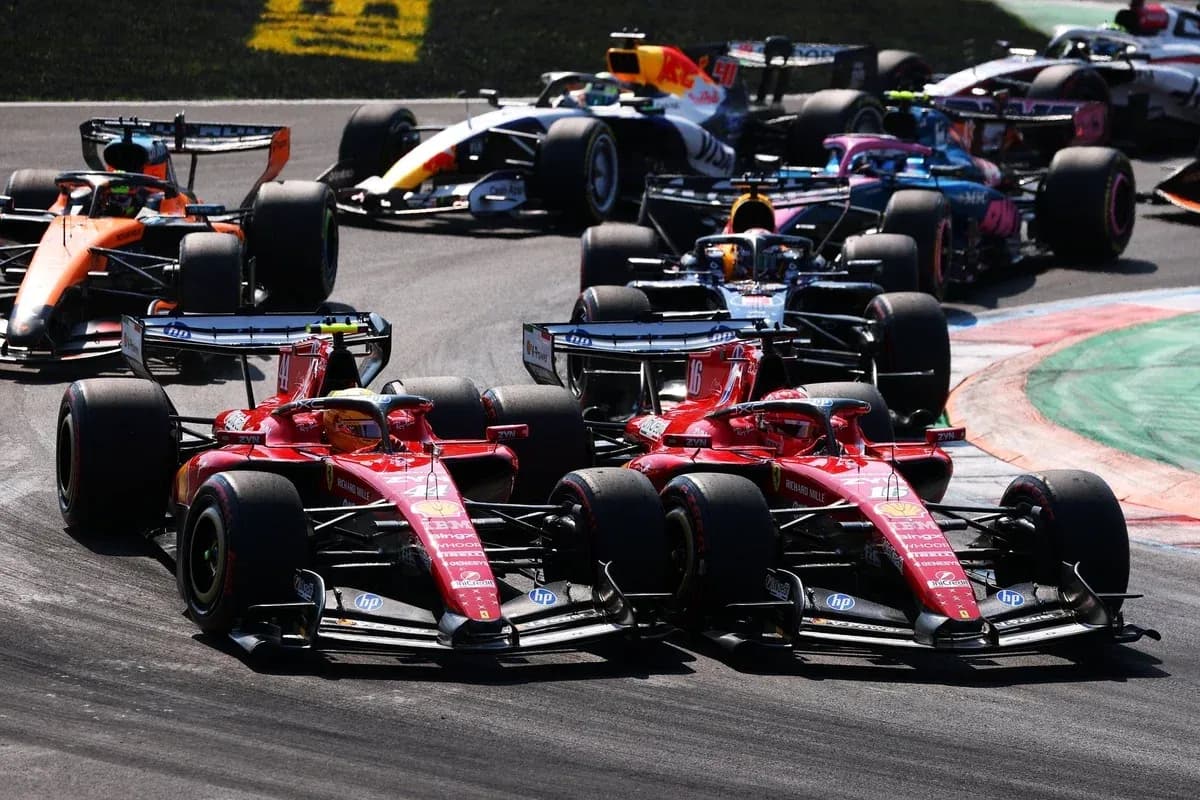 Two Ferrari cars racing closely on track Two Ferrari cars racing closely on track