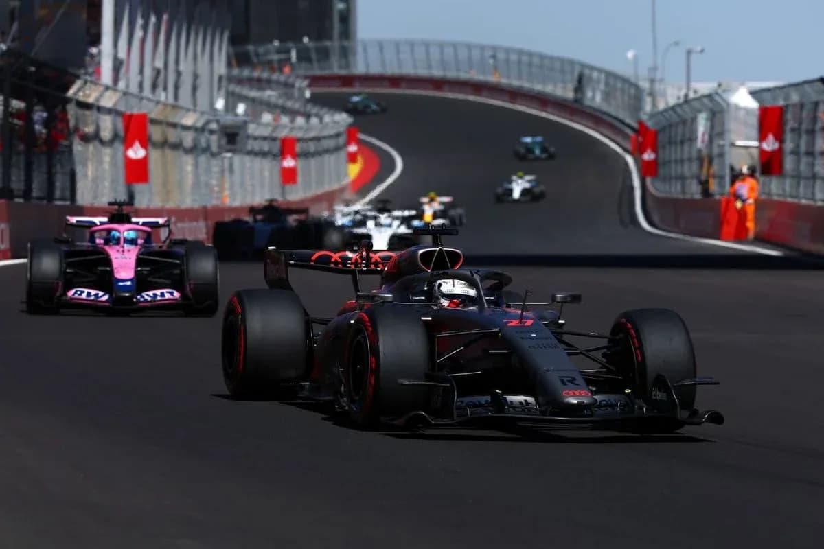 Formula 1 cars racing on a winding track Formula 1 cars racing on a winding track