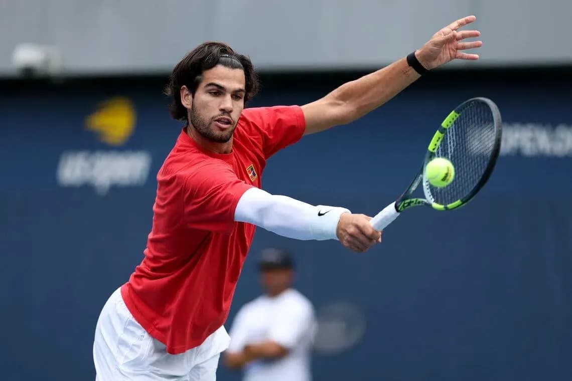 Player hitting a tennis ball during practice session Player hitting a tennis ball during practice session