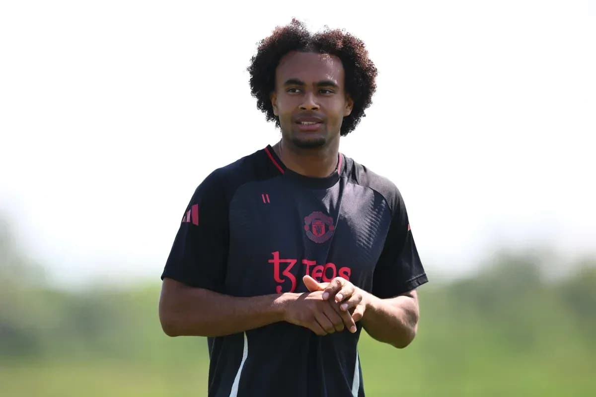 Player in Manchester United training kit on field Player in Manchester United training kit on field