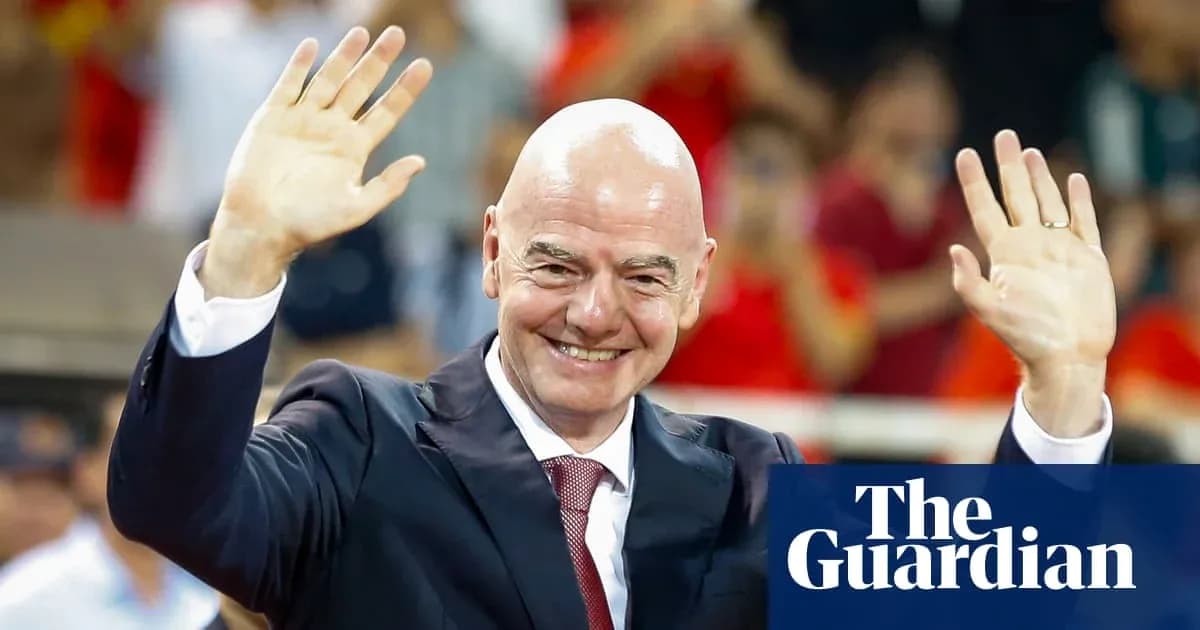 Man in suit waving at an event Man in suit waving at an event