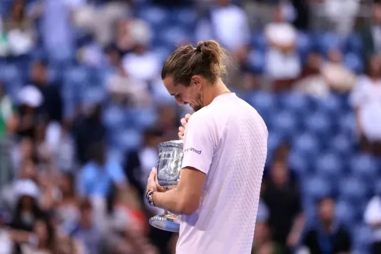 Player holding trophy after winning match Player holding trophy after winning match