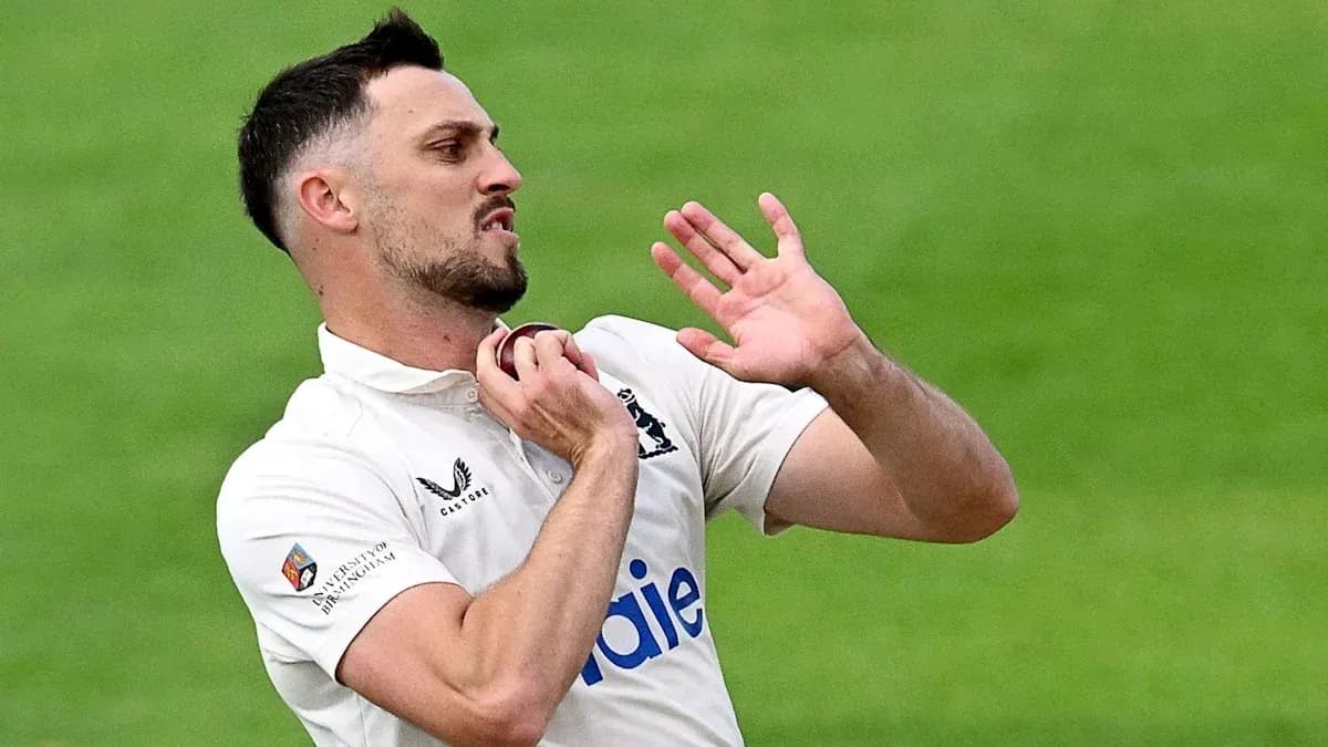 Cricketer adjusting collar during match action Cricketer adjusting collar during match action