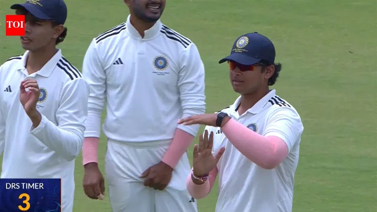 Cricket players discussing on the field during match Cricket players discussing on the field during match