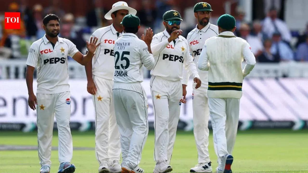Pakistani cricket players celebrating a wicket on field Pakistani cricket players celebrating a wicket on field