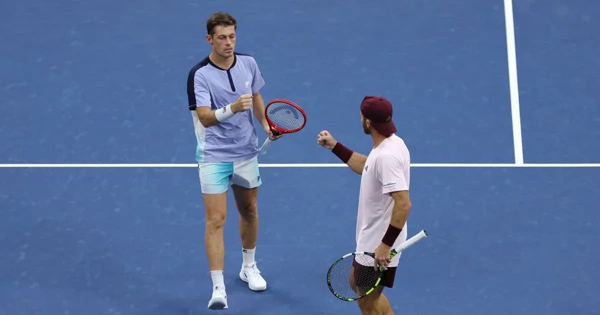 Two tennis players celebrating on the court Two tennis players celebrating on the court