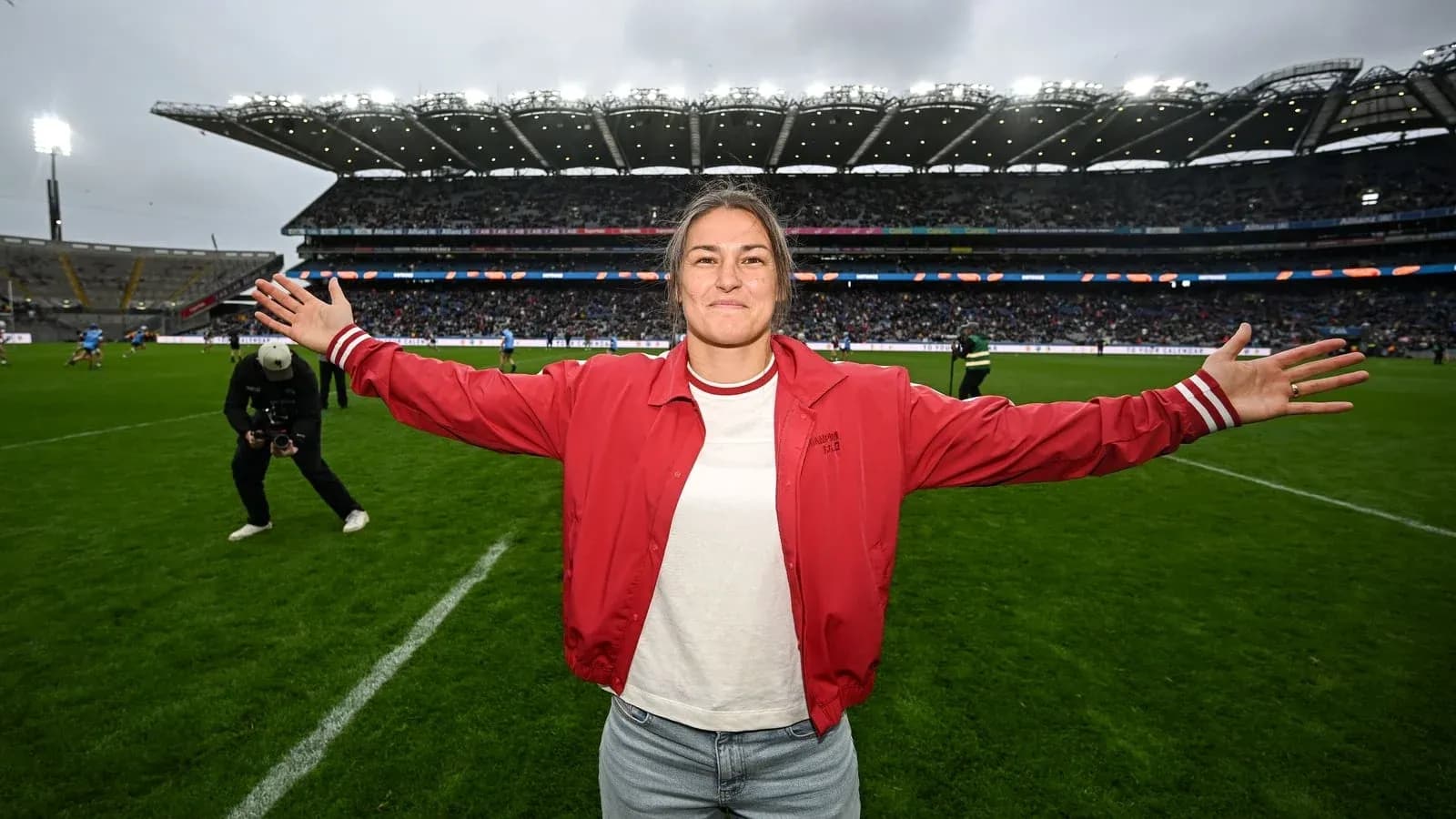 Woman with arms outstretched on sports field Woman with arms outstretched on sports field