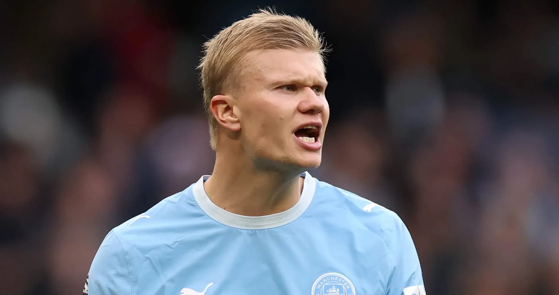 Player in Manchester City kit shouting on field Player in Manchester City kit shouting on field