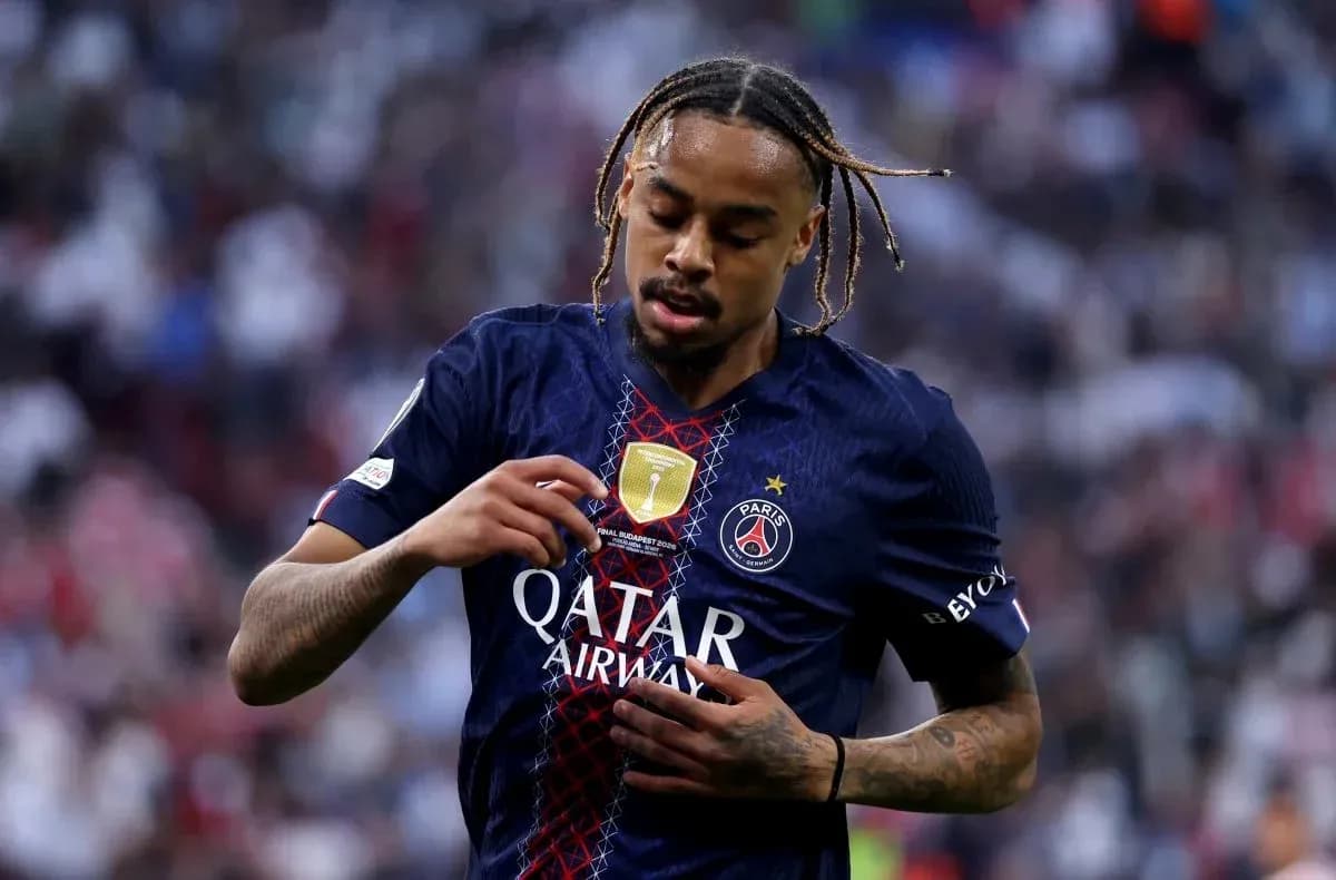 Player adjusting jersey with PSG logo during match Player adjusting jersey with PSG logo during match