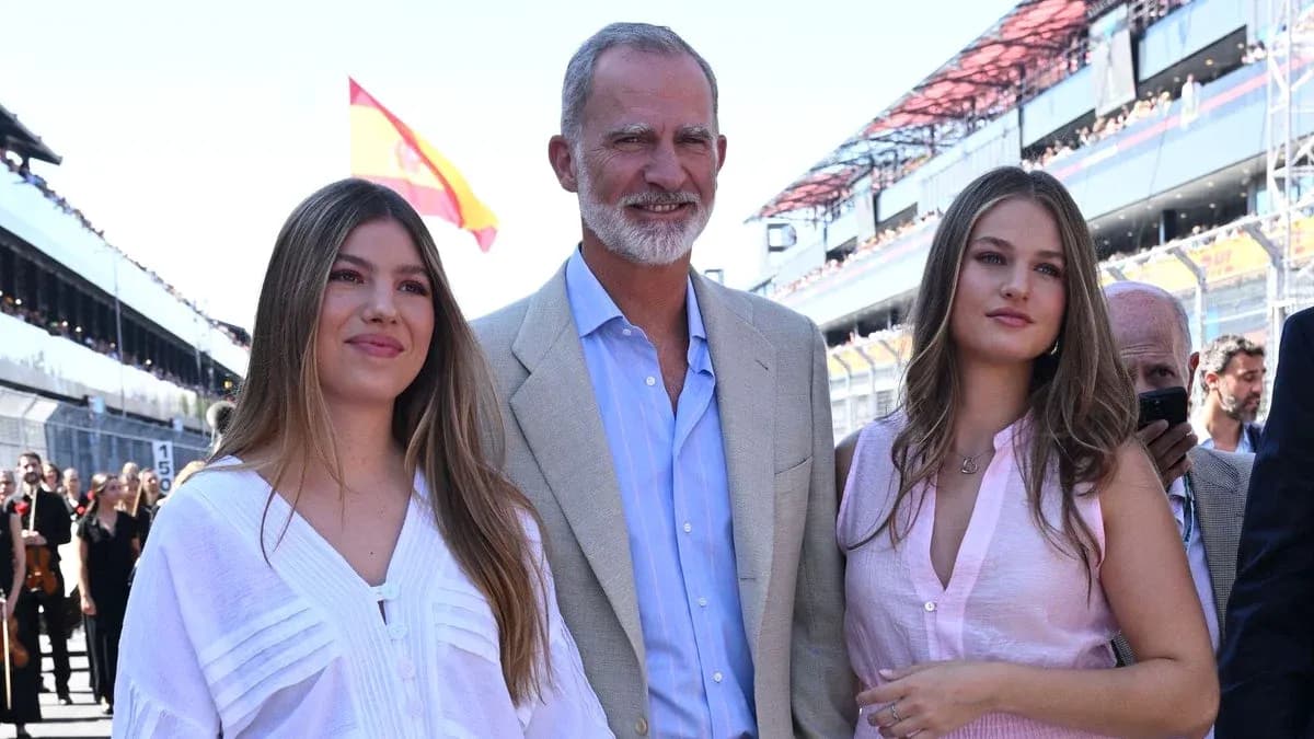 Three people posing at a racing event venue Three people posing at a racing event venue