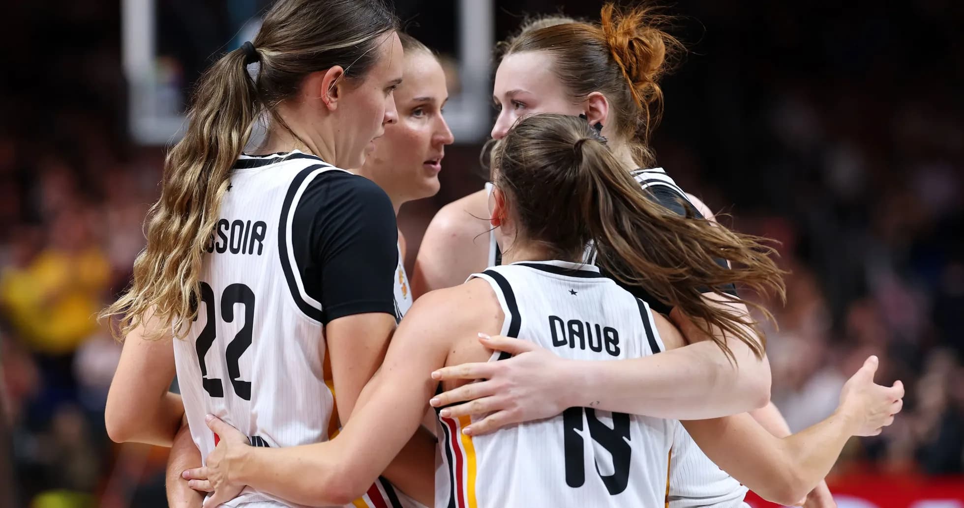 Players celebrating in a team huddle during game Players celebrating in a team huddle during game