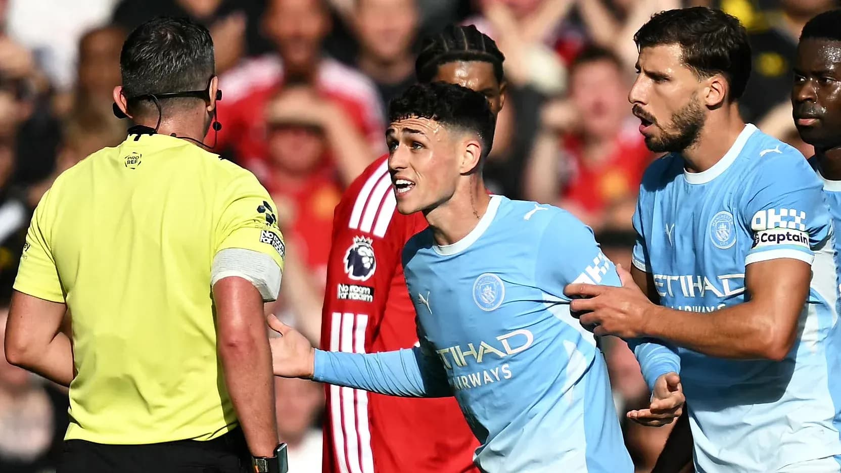 Manchester City players arguing with the referee Manchester City players arguing with the referee