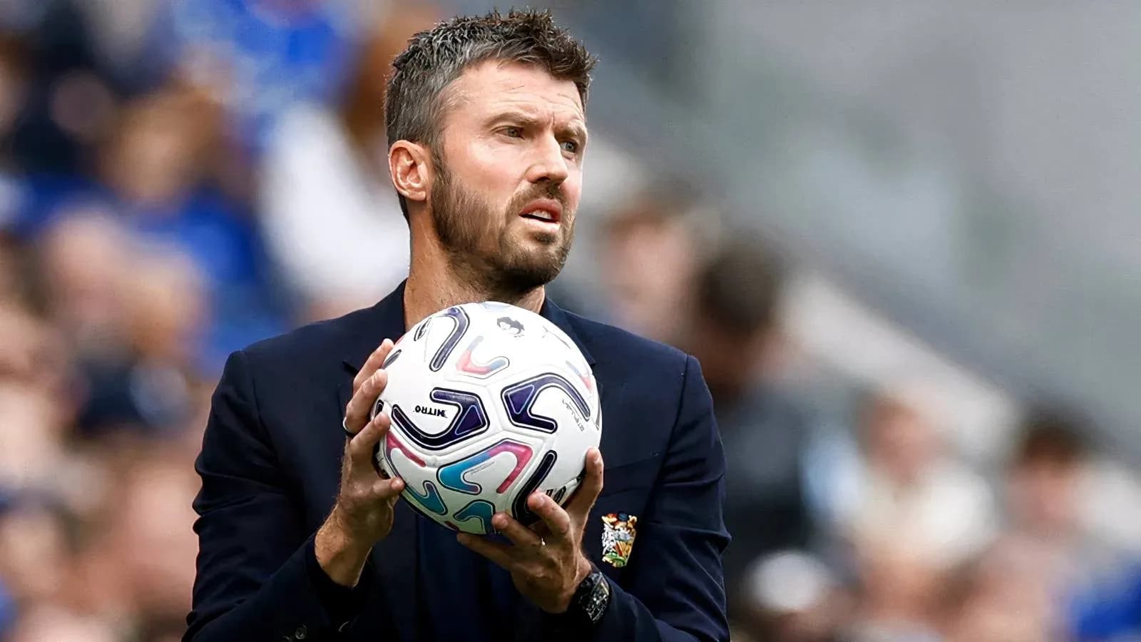 Coach holding a soccer ball on the sidelines Coach holding a soccer ball on the sidelines
