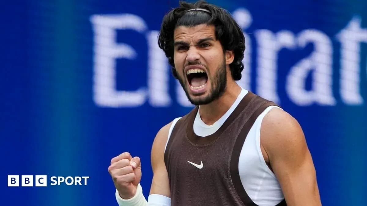 Tennis player celebrating victory with raised fist Tennis player celebrating victory with raised fist