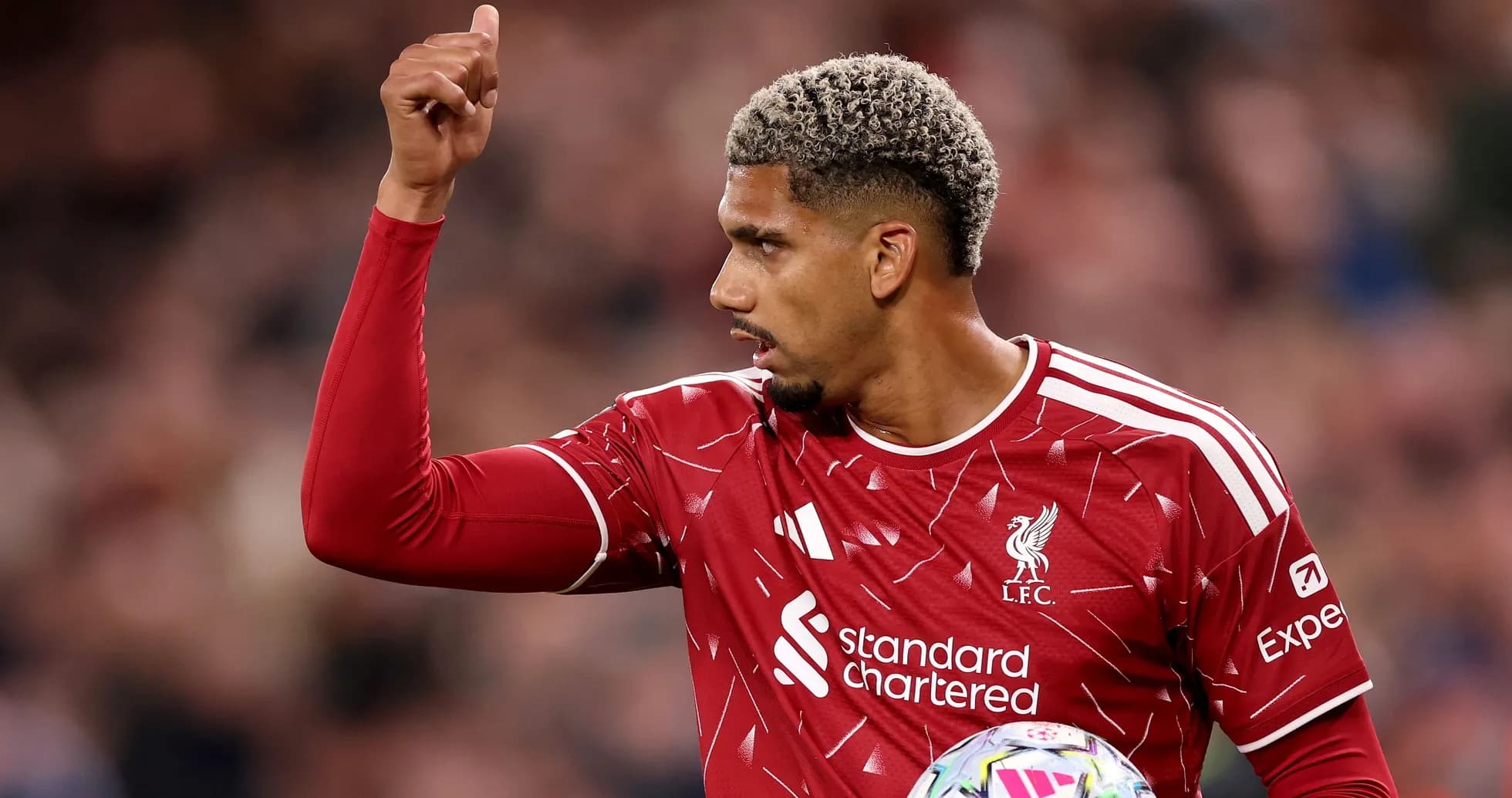 Player gesturing during match wearing Liverpool jersey Player gesturing during match wearing Liverpool jersey