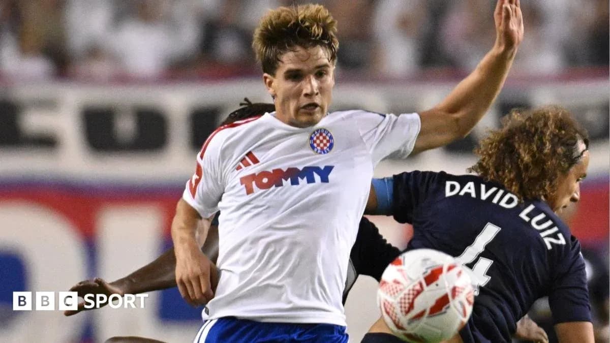 Player in white shirt challenging opponent during match Player in white shirt challenging opponent during match