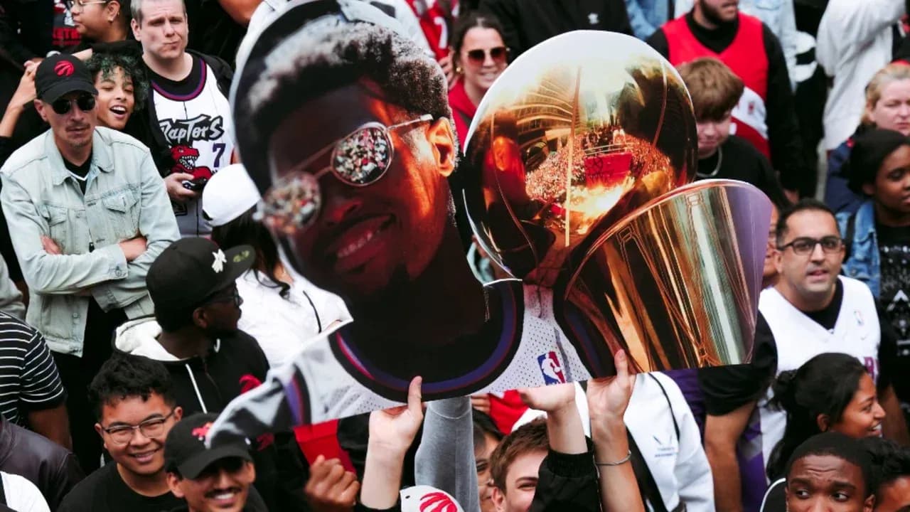 Fans celebrating with a large trophy and poster Fans celebrating with a large trophy and poster