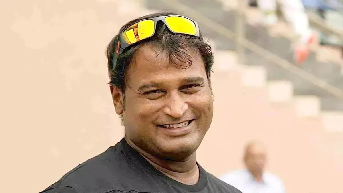 Man smiling wearing sunglasses at sports venue Man smiling wearing sunglasses at sports venue