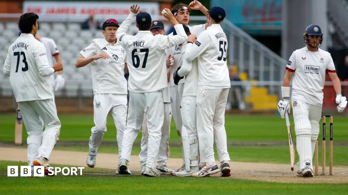 Players celebrating a wicket during a cricket match Players celebrating a wicket during a cricket match