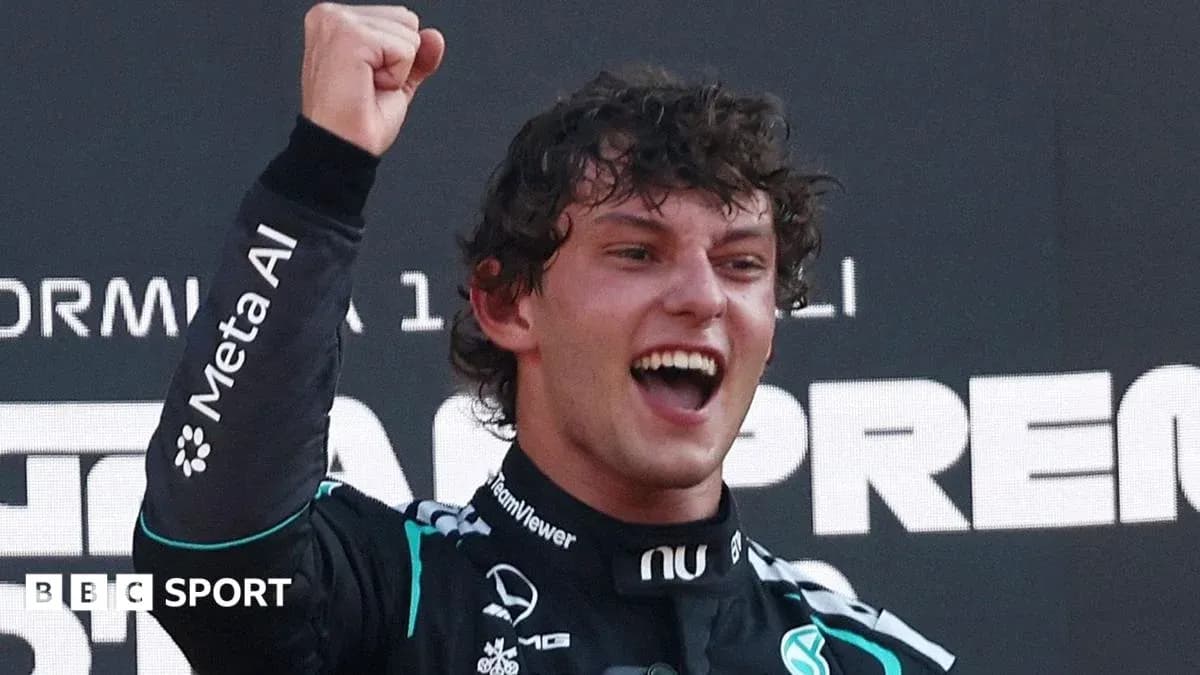 Driver celebrating with raised fist on podium Driver celebrating with raised fist on podium
