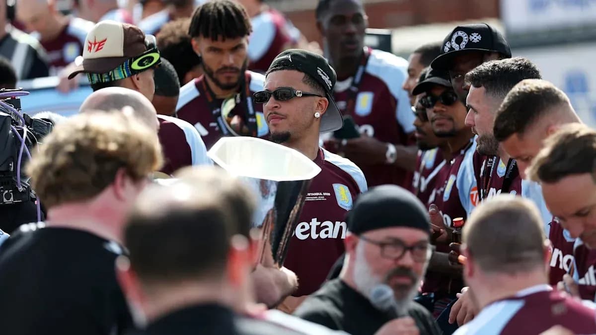 Aston Villa players celebrating with trophy in crowd Aston Villa players celebrating with trophy in crowd