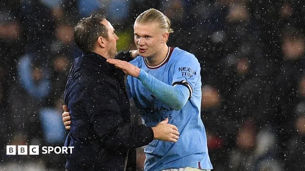Player and coach embracing in rainy stadium Player and coach embracing in rainy stadium