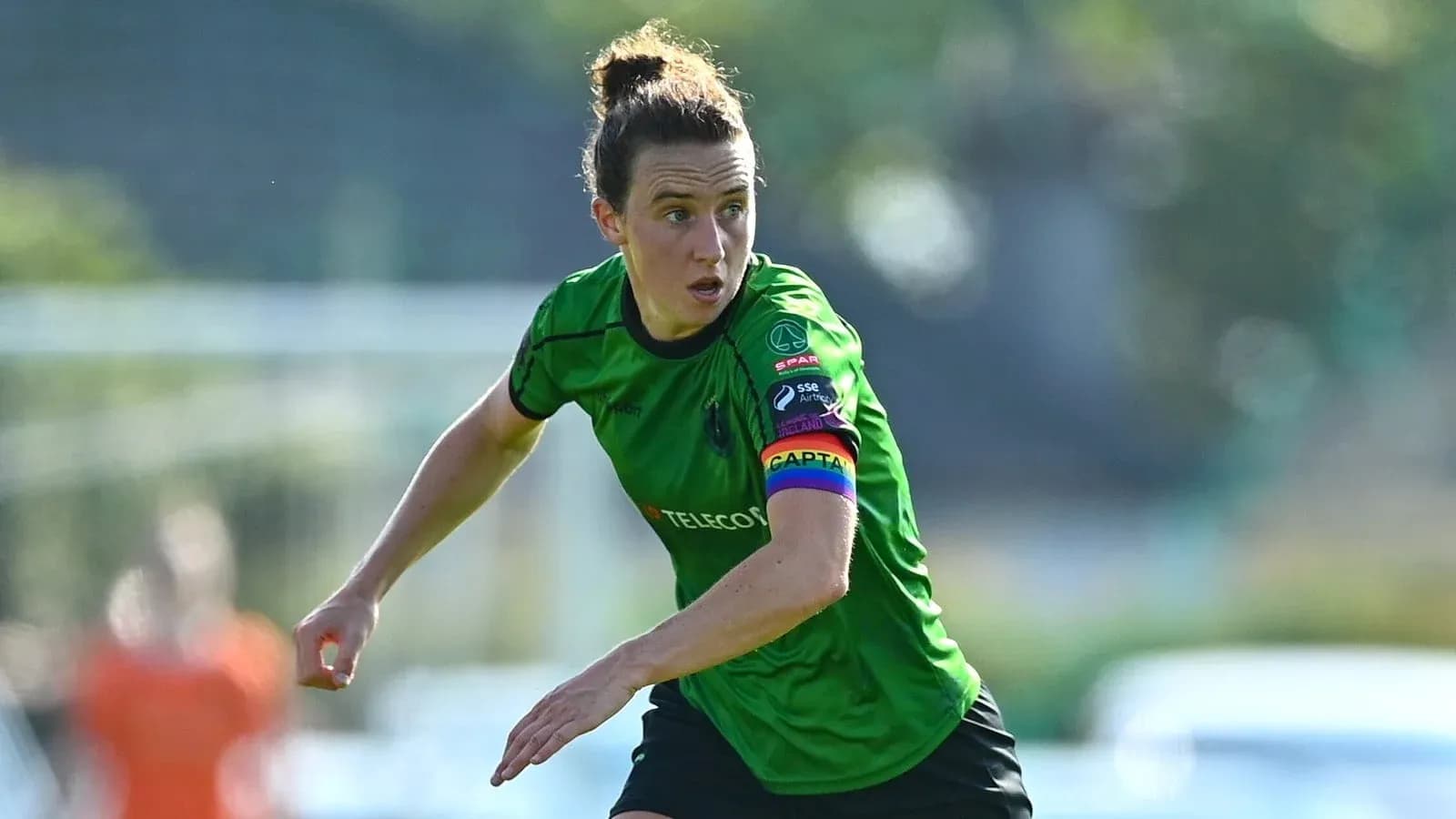 Player in green kit running on the field Player in green kit running on the field