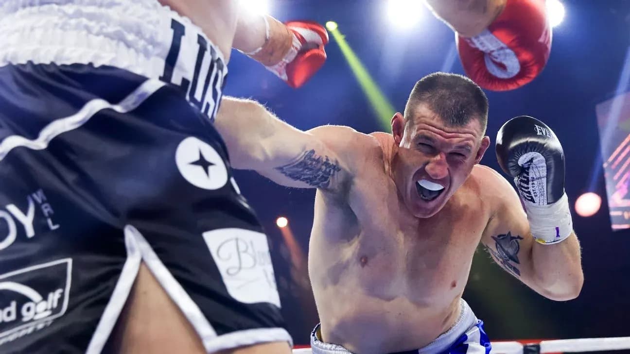 Boxer delivering a punch during a match Boxer delivering a punch during a match