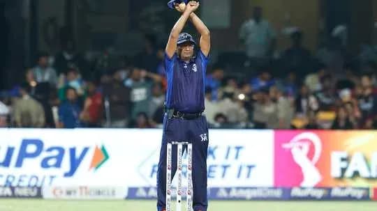 Umpire signaling a decision during a cricket match Umpire signaling a decision during a cricket match