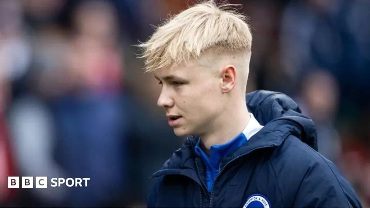 Player in team jacket walking on the pitch Player in team jacket walking on the pitch