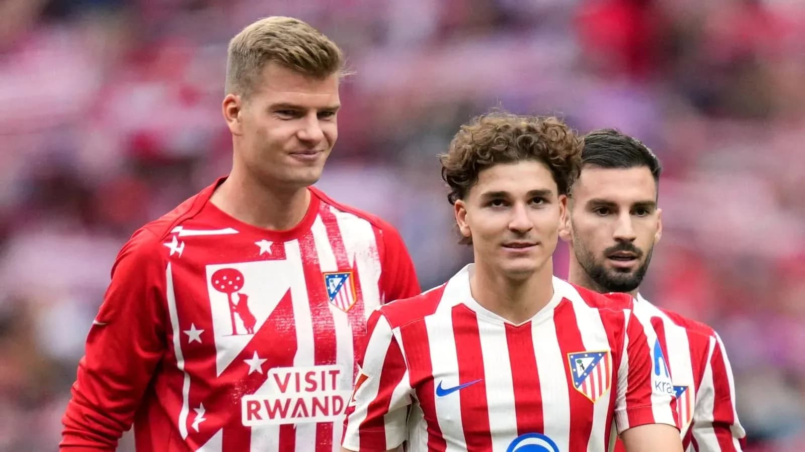 Three Atlético Madrid players in team jerseys Three Atlético Madrid players in team jerseys